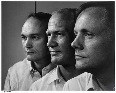 Black and white photo of the profiles of three men, each wearing collared shirts.