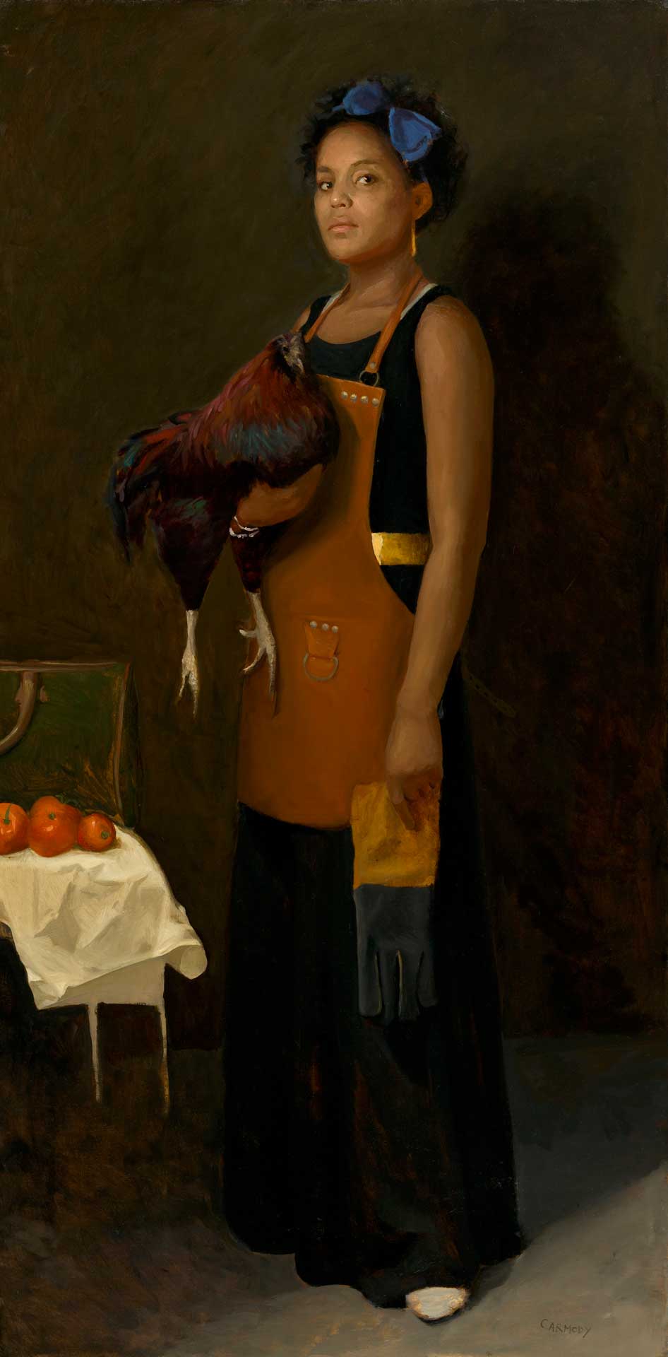 Woman standing with rooster in hands