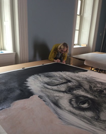 Working on the large Baldessari portrait, the portrait laying on a stretcher