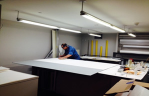 Working on the large Baldessari portrait in the conservation and framing lab