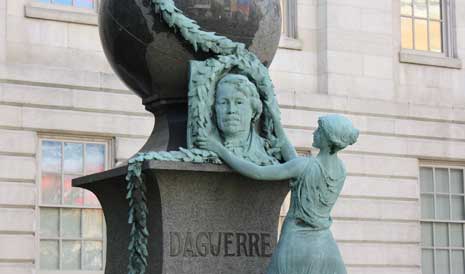 Daguerre monument -- bronze bust of Daguerre with large stone globe on top,
