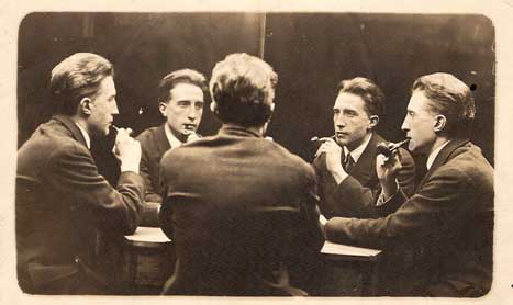 Photograph of five Marcel Duchamp's sitting around table