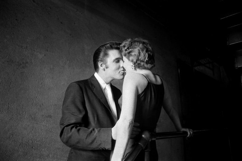 Young elvis in formal attire kissing girl