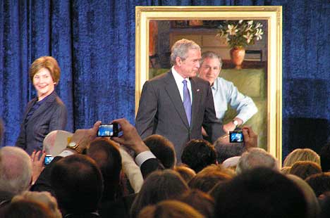 George and Laura Bush on stage, during portrait ceremony