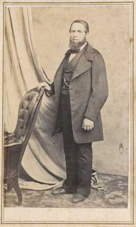  Domingo Ghirardelli standing, with hand on chair