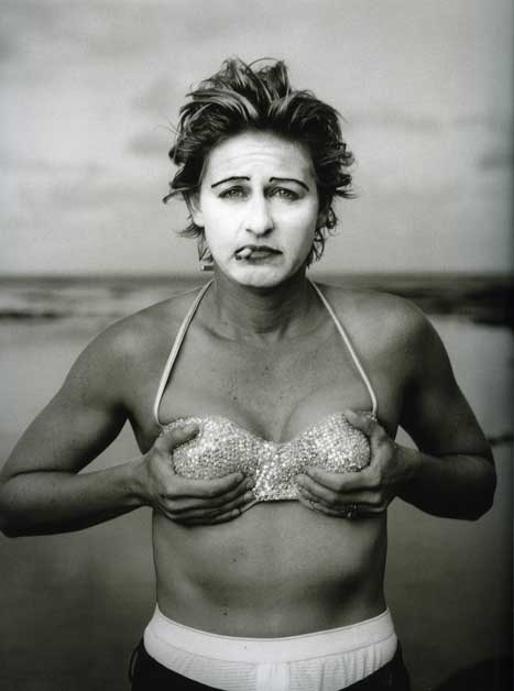 Blog_hide_seek_degeneres Black and white photo of Ellen Degeneres, wearing white makeup on her face and clurching her chest
