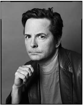 Black and white photo of Michael J. Fox with hand clutched underneath chin