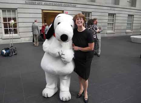 Molly Grimsley with Snoopy in museum courtyard