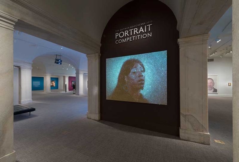 Exhibition entrnace, with projector art portrait