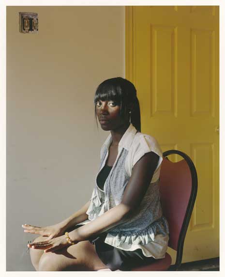 Photo of young African American woman sitting in chair