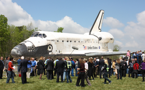 The Space Shuttle Discovery surrounded by journalists