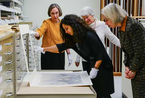 Taina Caragol looking at portraits in the museum's collections