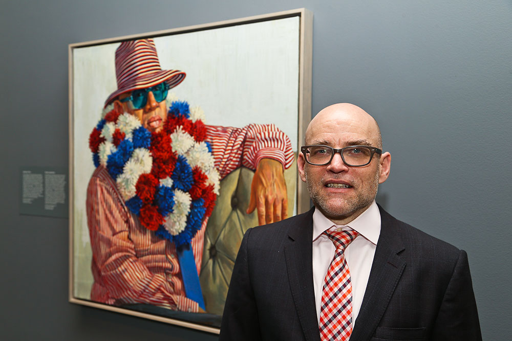 The artist Tim Dowd standing in front of his artwork, in The Outwin exhibition