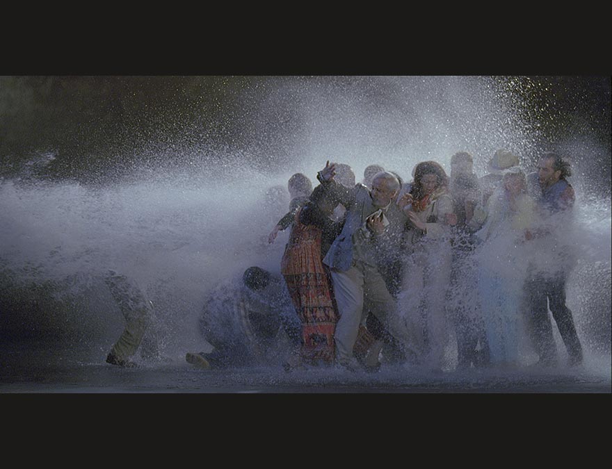 Groups of people being sprayed with water by a high-powered hose