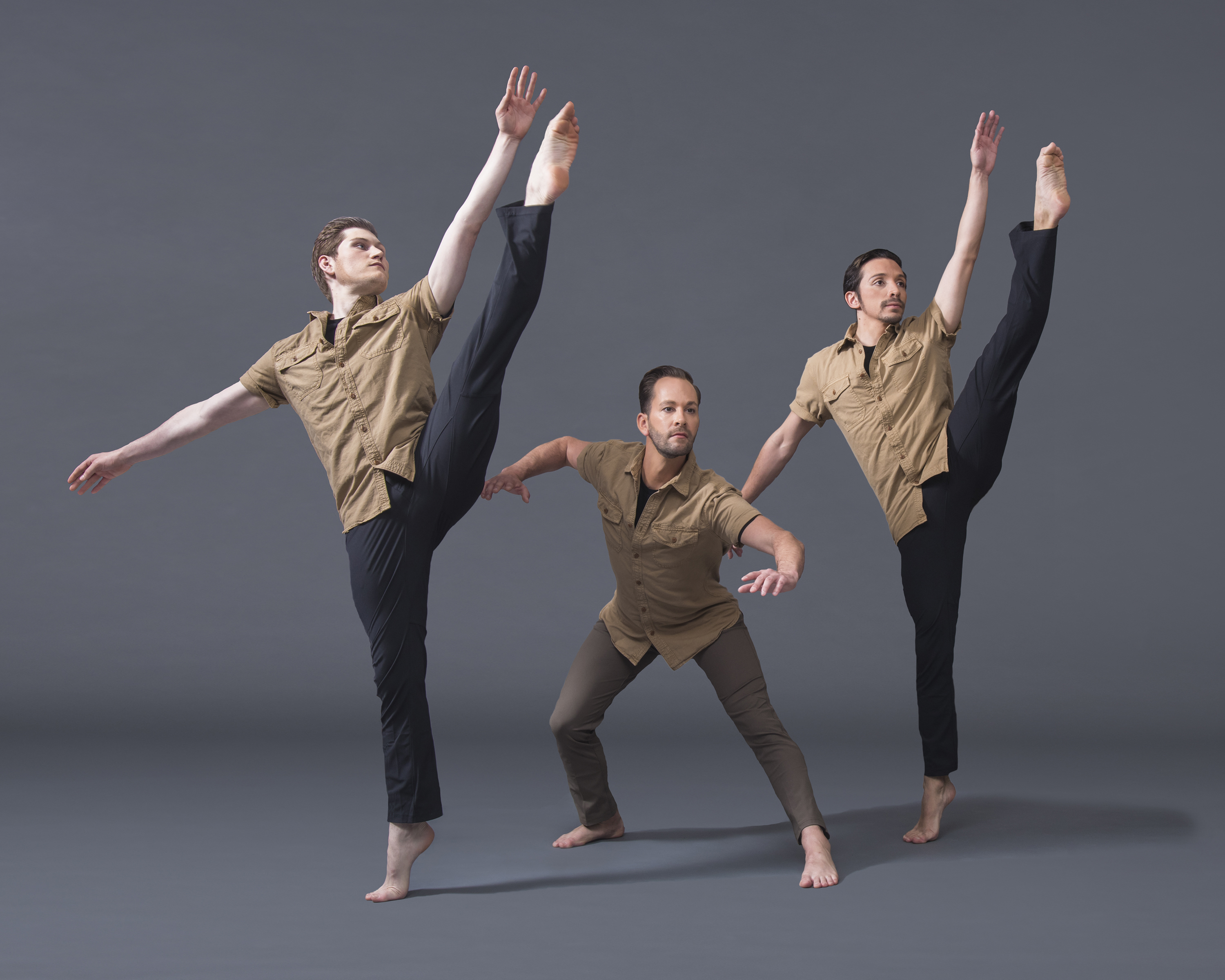 Image of three men dancing in a line