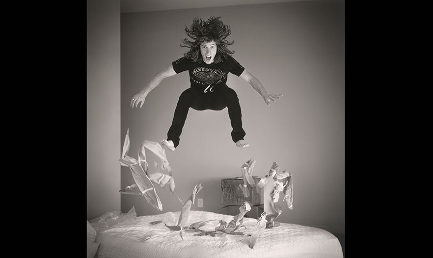 Man jumping on a bed
