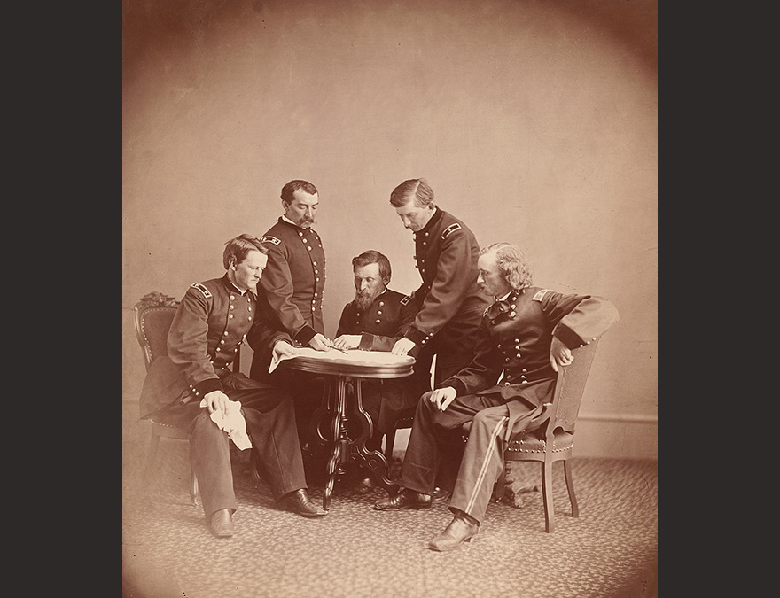 Several military men grouped around a table