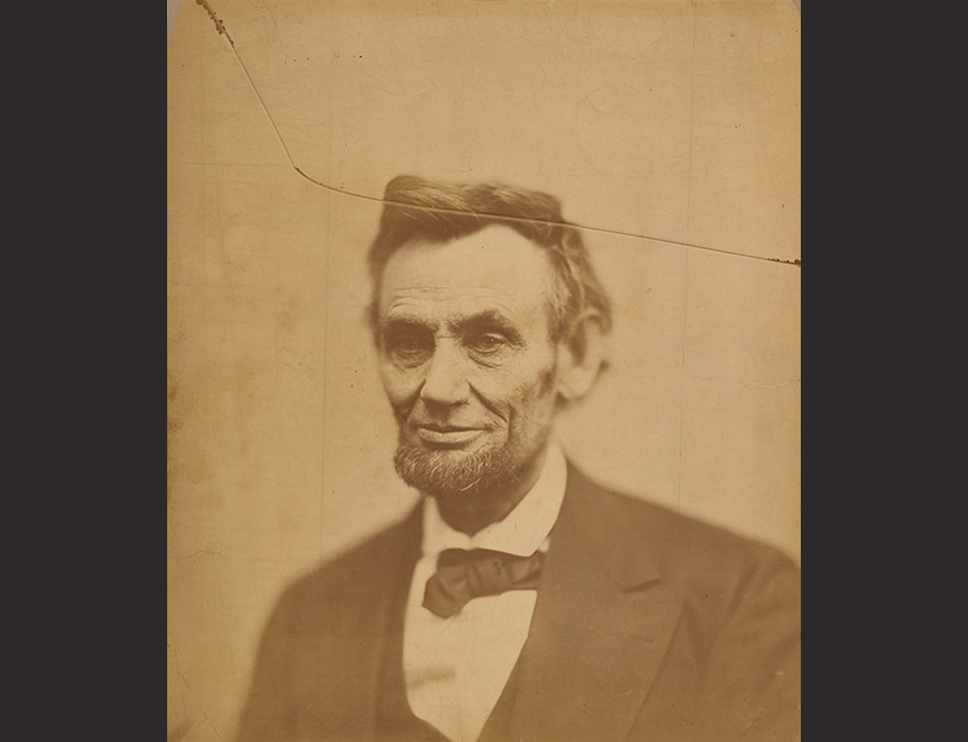 Bust-length vew of a man with a beard wearing a suit