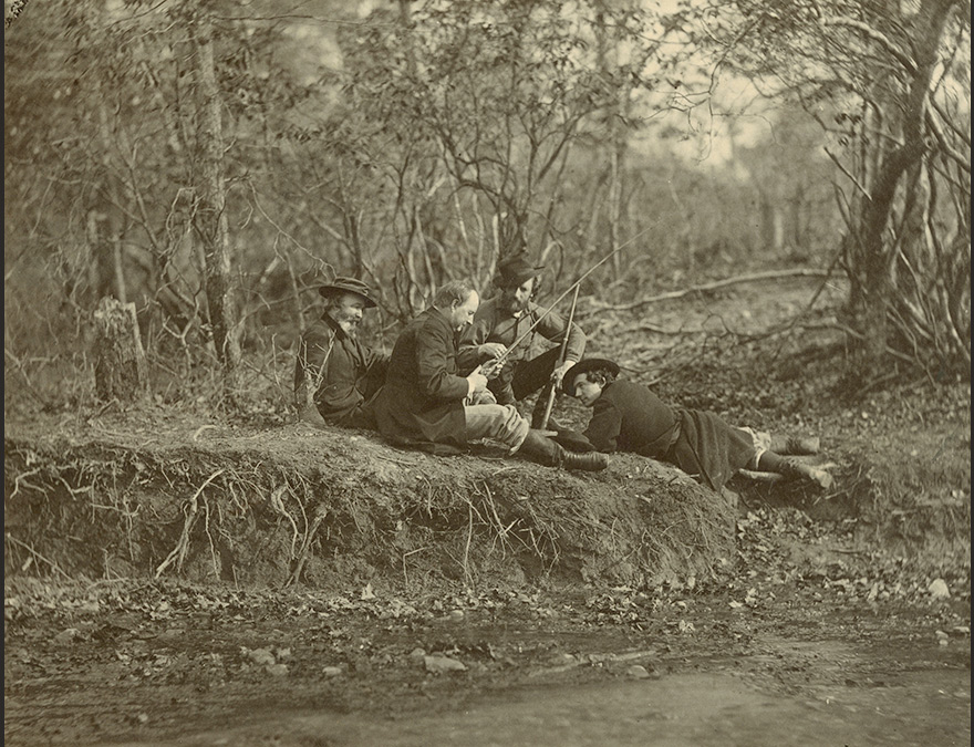 Group of men reclining in the forest