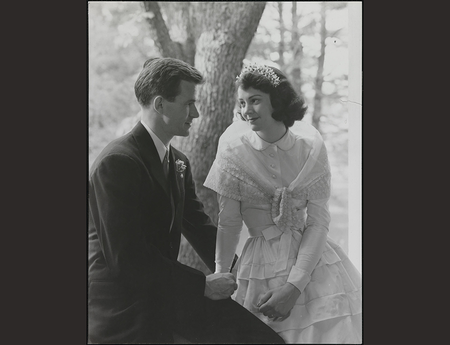 Young man and woman holding hands and looking at each other