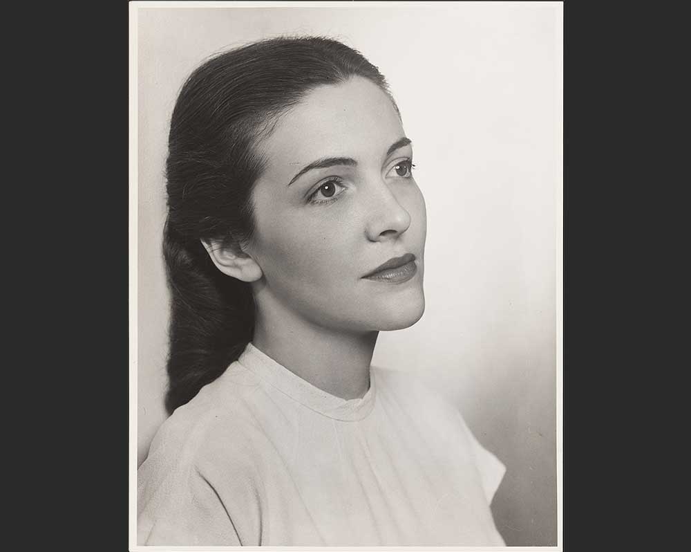 Black and white photo of a woman in a white dress