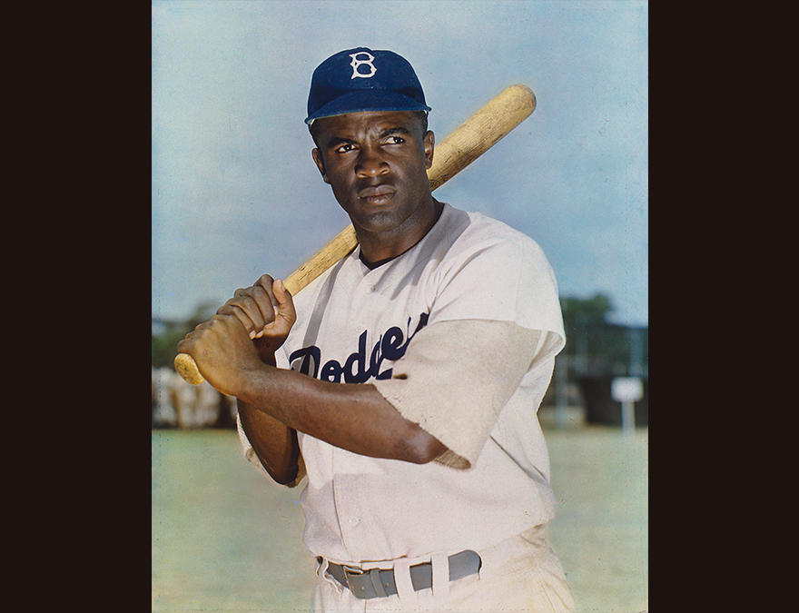 African American man in a baseball uniform holding a bat