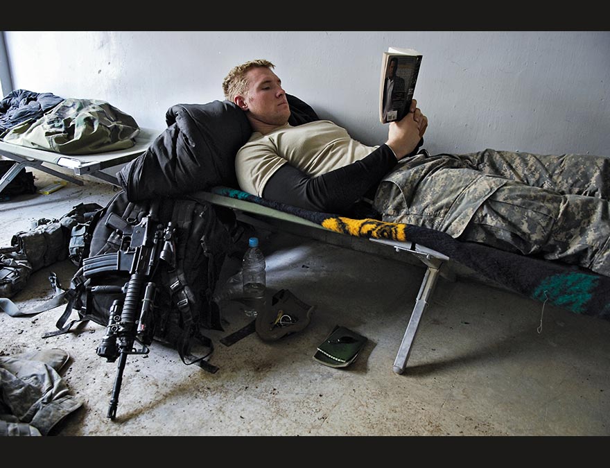 Soldier on a cot reading