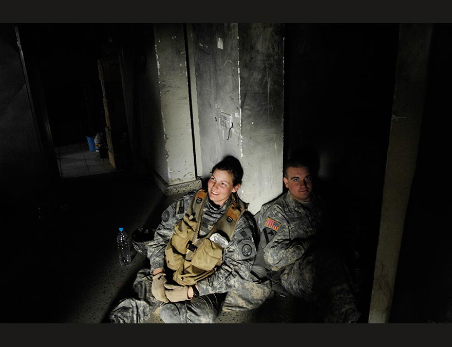 Solders (including the photographer) in a bunker in the dark