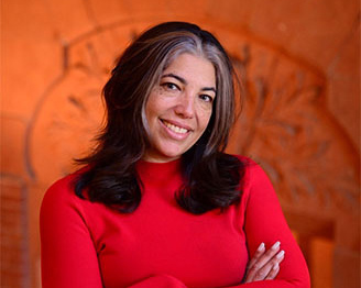 African American woman with long black hair in a red sweater