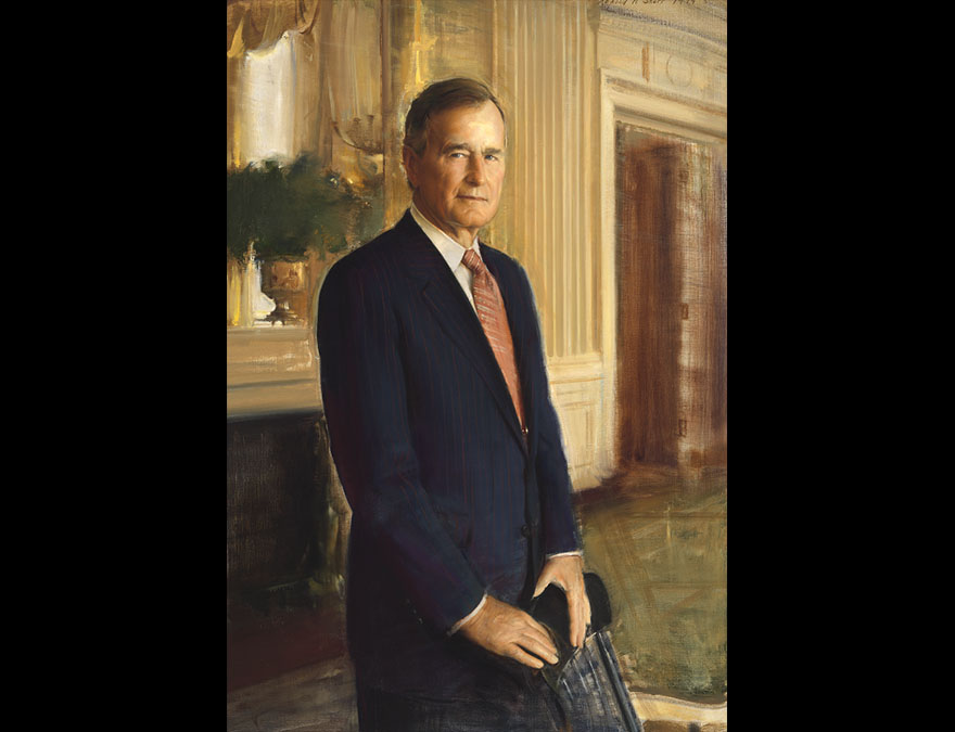3/4 length view of a man in a suit standing in the Oval Office