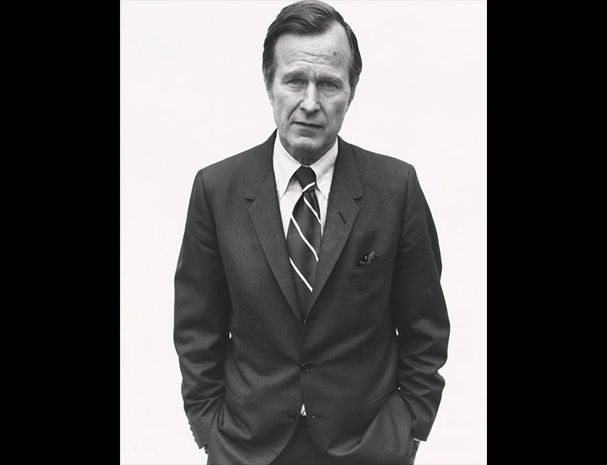 3/4 length view of a man in a dark suit