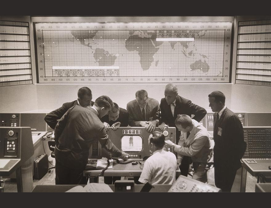 A group of astronauts around a console