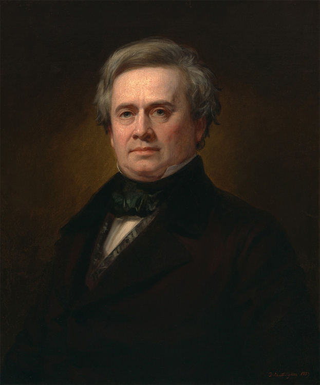 bust length portrait of a gray-haired man in a black suit