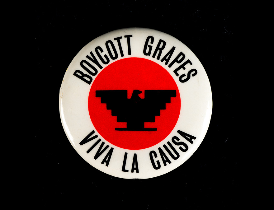 A red, white and black button with an eagle in the center