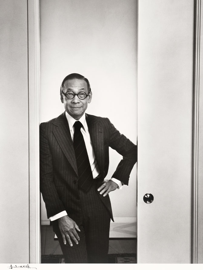 Man in round glasses standing in a doorway