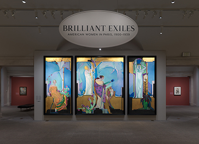 A tall three-paneled series of paintings underneath the Brilliant Exiles exhibition entrance sign.
