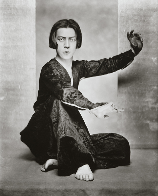 Black and white photo of an Asian dancer with cropped hair in a dance pose