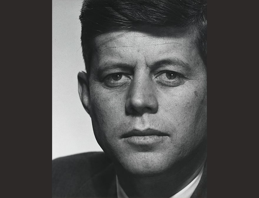 Black and white, close-up photo of a man with dark hair (JFK)