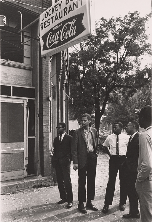 Group of African American men standing on a street corner