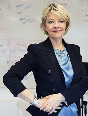 waist length photo of a woman with blond hair wearing a blue blazer