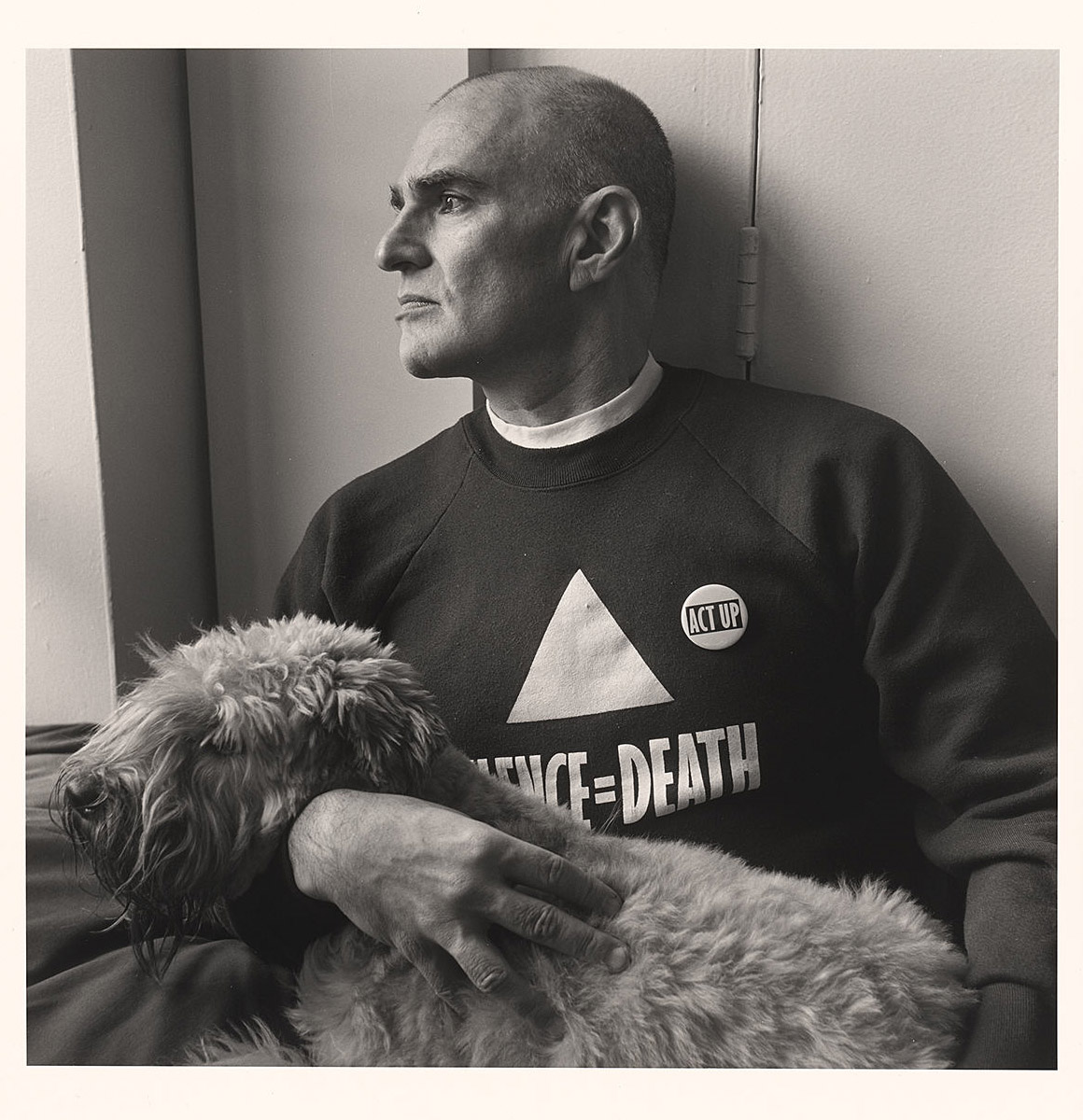 Man in a sweatshirt with his dog