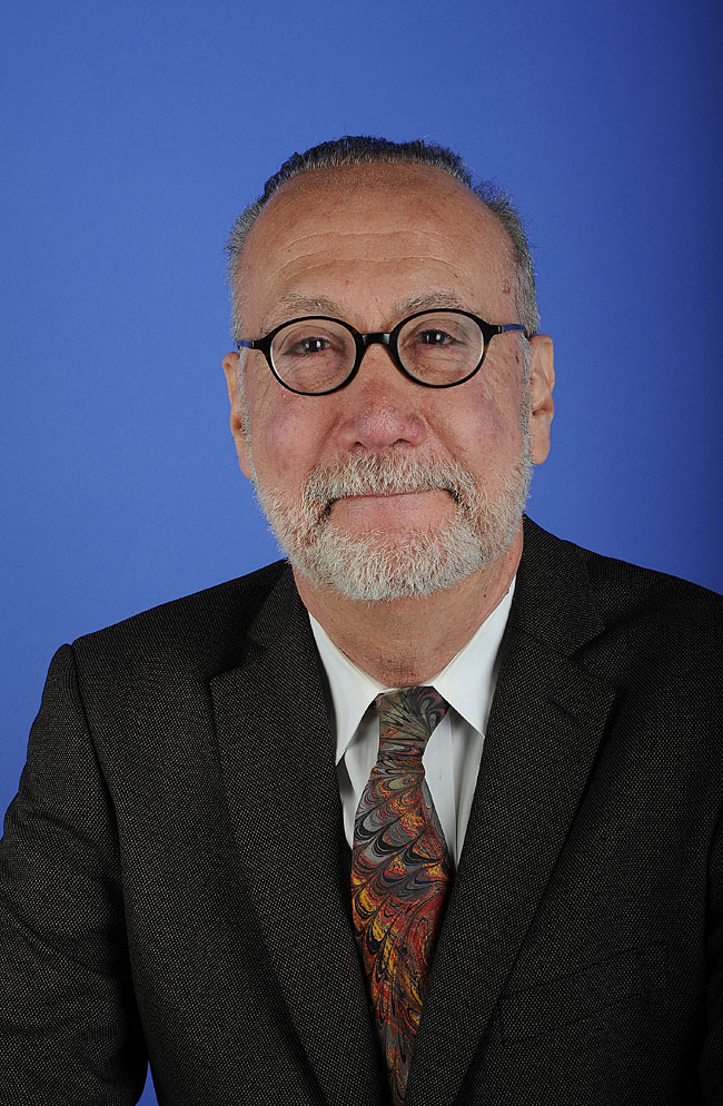 bust length photo fo a balding man with round glasses