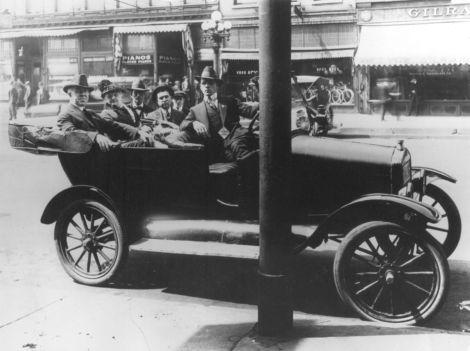 A black and white image of people in a car