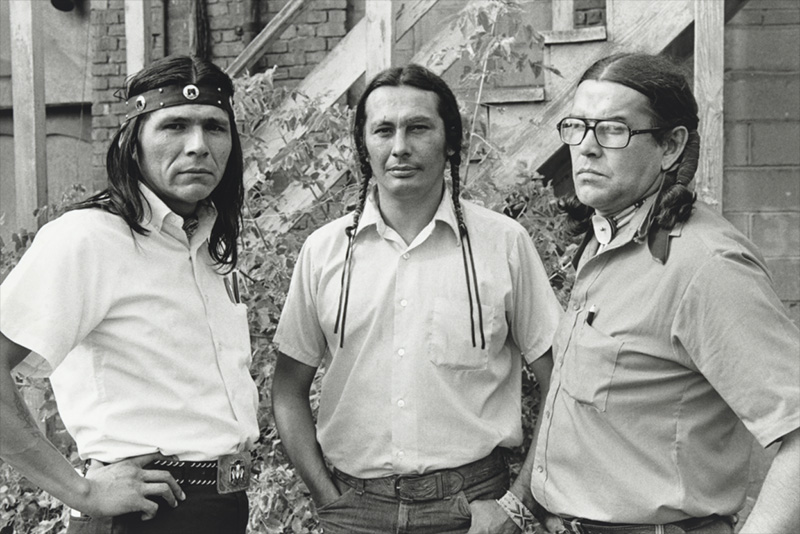 Waist length photo of three Native American men in shirtsleeves