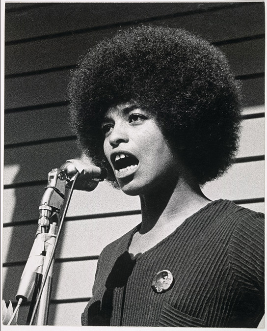 African American woman speaking at a microphone