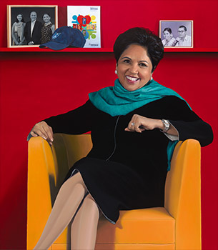 woman in a black dress seated against a red background