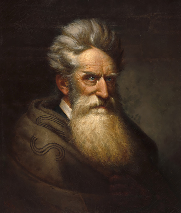 Waist length portrait of a bearded man with wild hair
