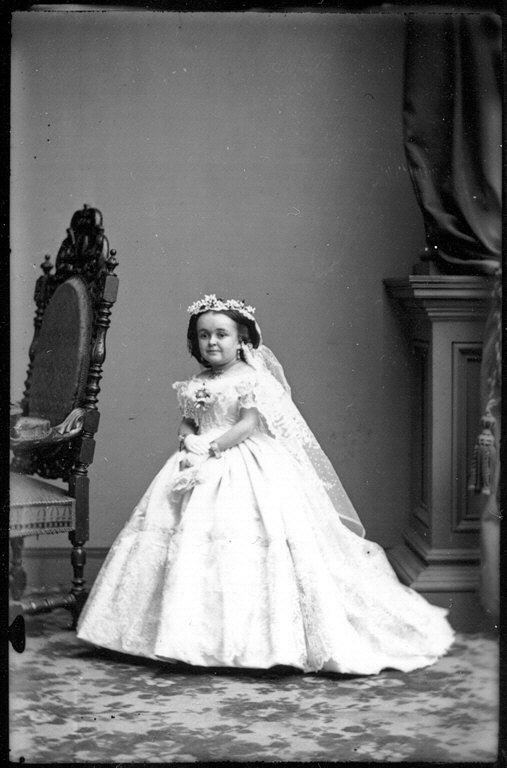 full length portrait of a little person in a wedding gown