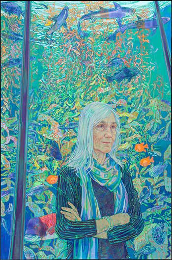 woman standing before a colorful aquarium