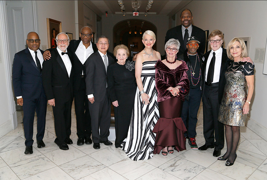a group of celebrities in formalwear